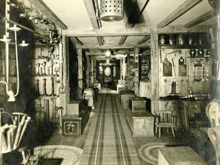 A room filled with tools, furniture, and other items of daily life from the 1800s