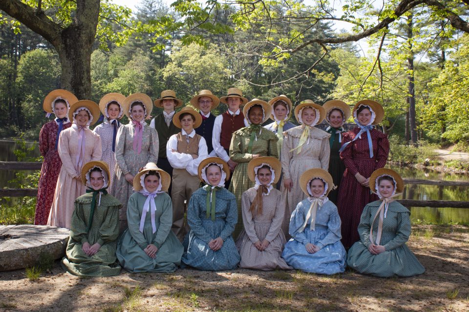 Nearly two dozen high school students wearing 1830s style clothing