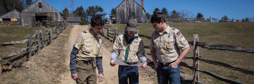 3 Boy Scouts in uniform explore Old Sturbridge Village