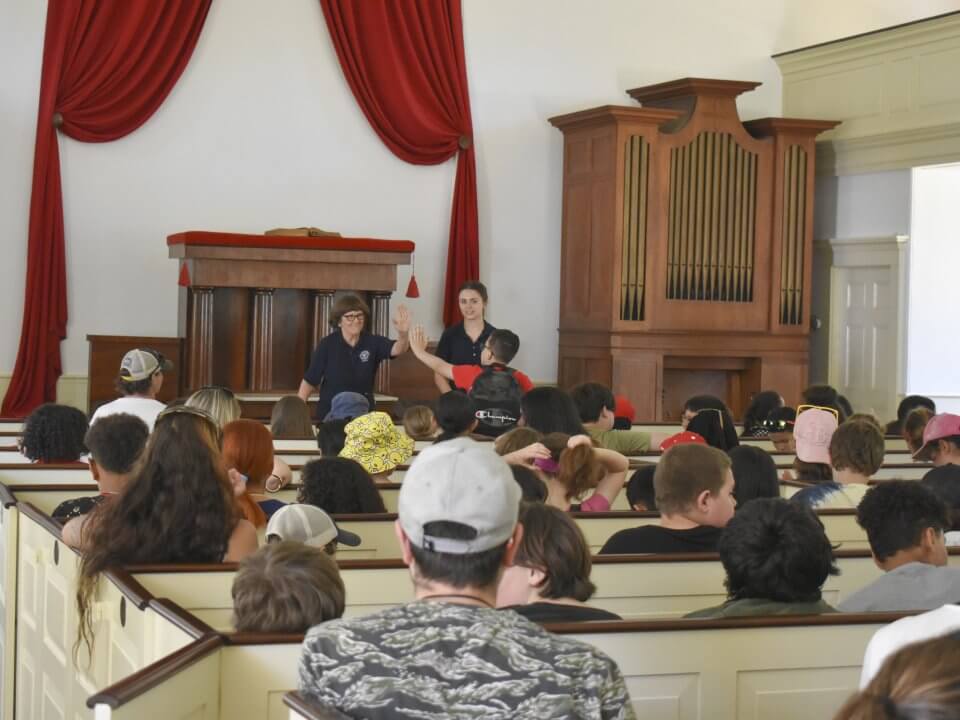 Kids sitting in the Center Meetinghouse for a discussion