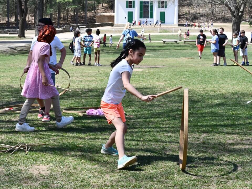 Kids playing trundling hoops on the Village Common