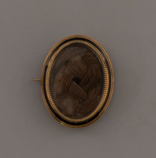 Braided hair in a broach