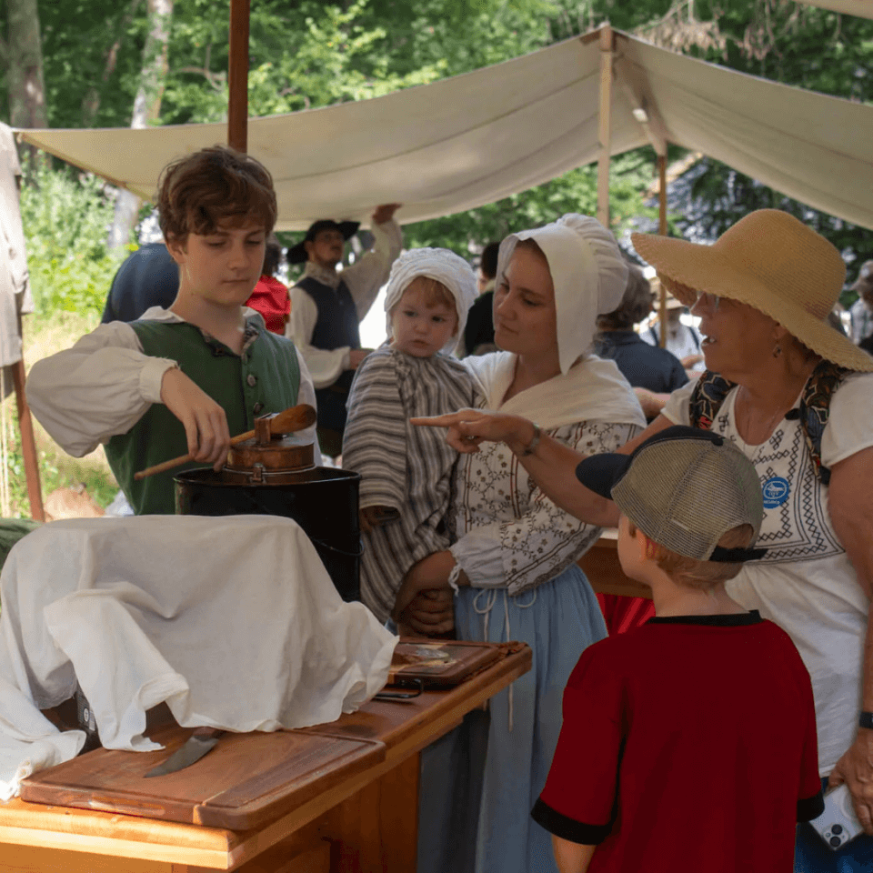 Visitors chat with Redcoats & Rebels Reenactors in a camp