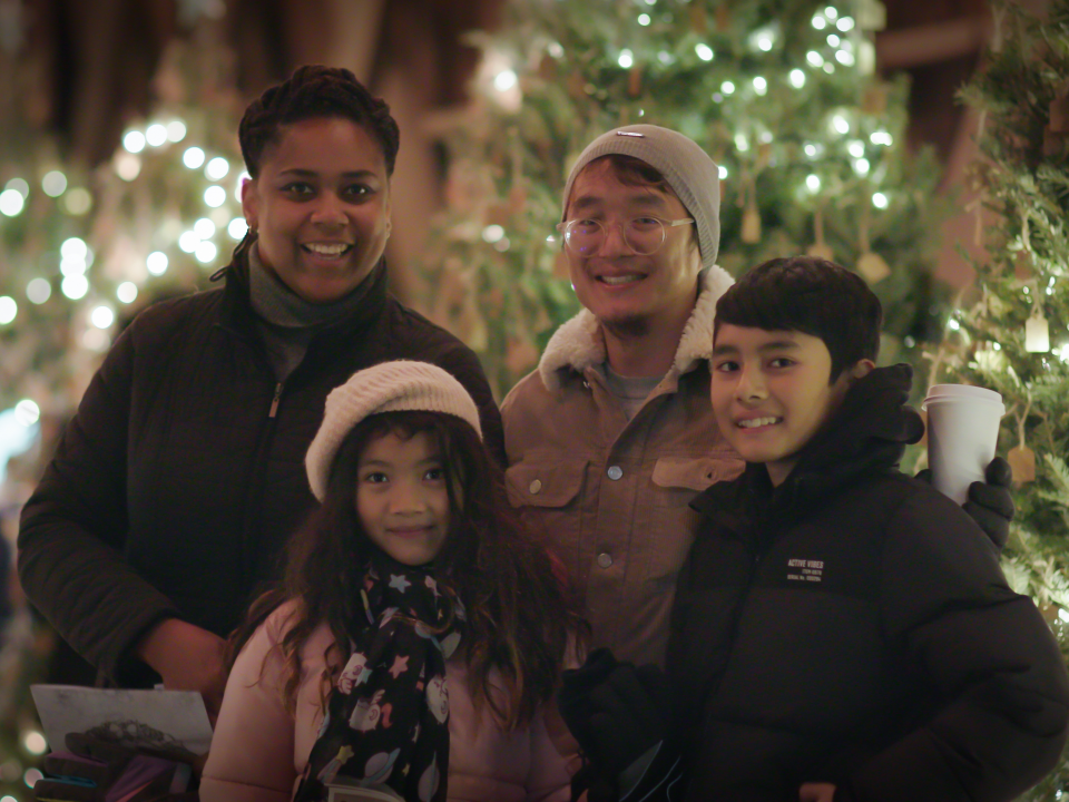 A Family Poses for a Photo on the Christmas Wish Bridge